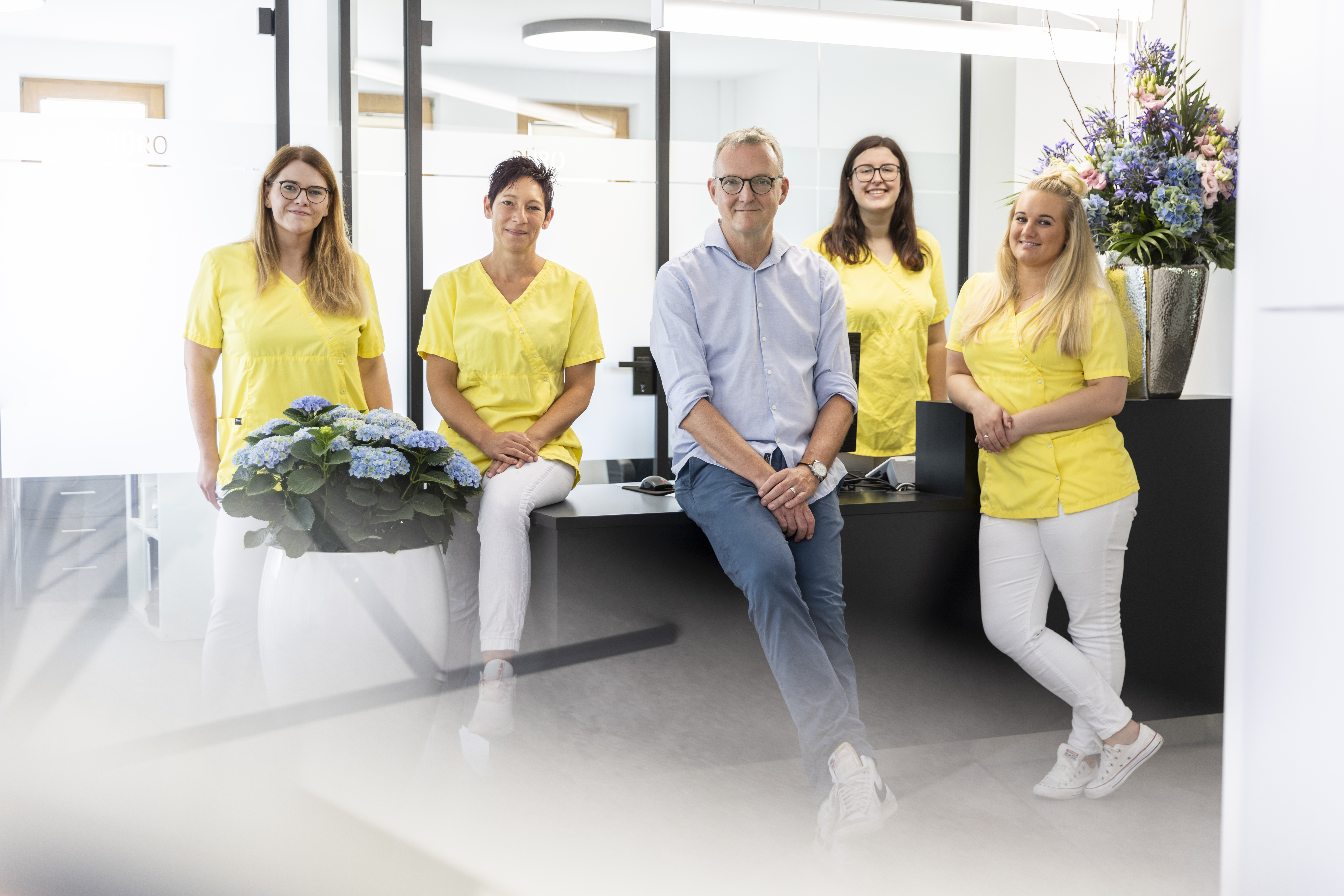 Image with 4 smiling women, staff members